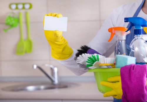 Kitchen domestic cleaning in an E16 home with worktops, sink, and appliances being wiped down